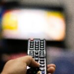 Person Holding Black Remote Control